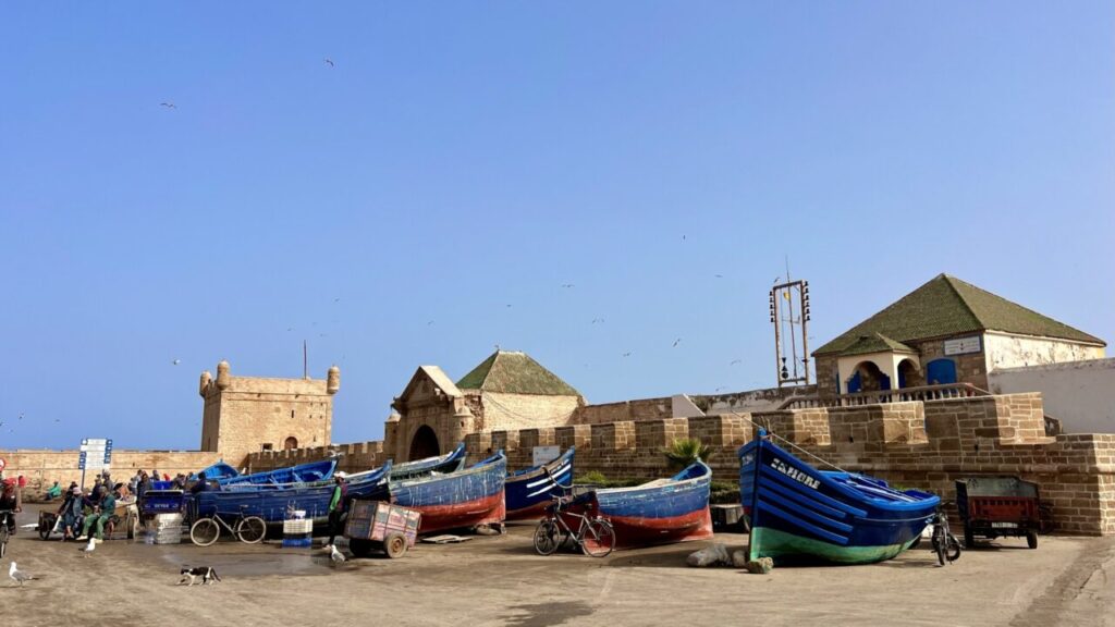 Blue fishing boats at the harbor wall of Essaouira
